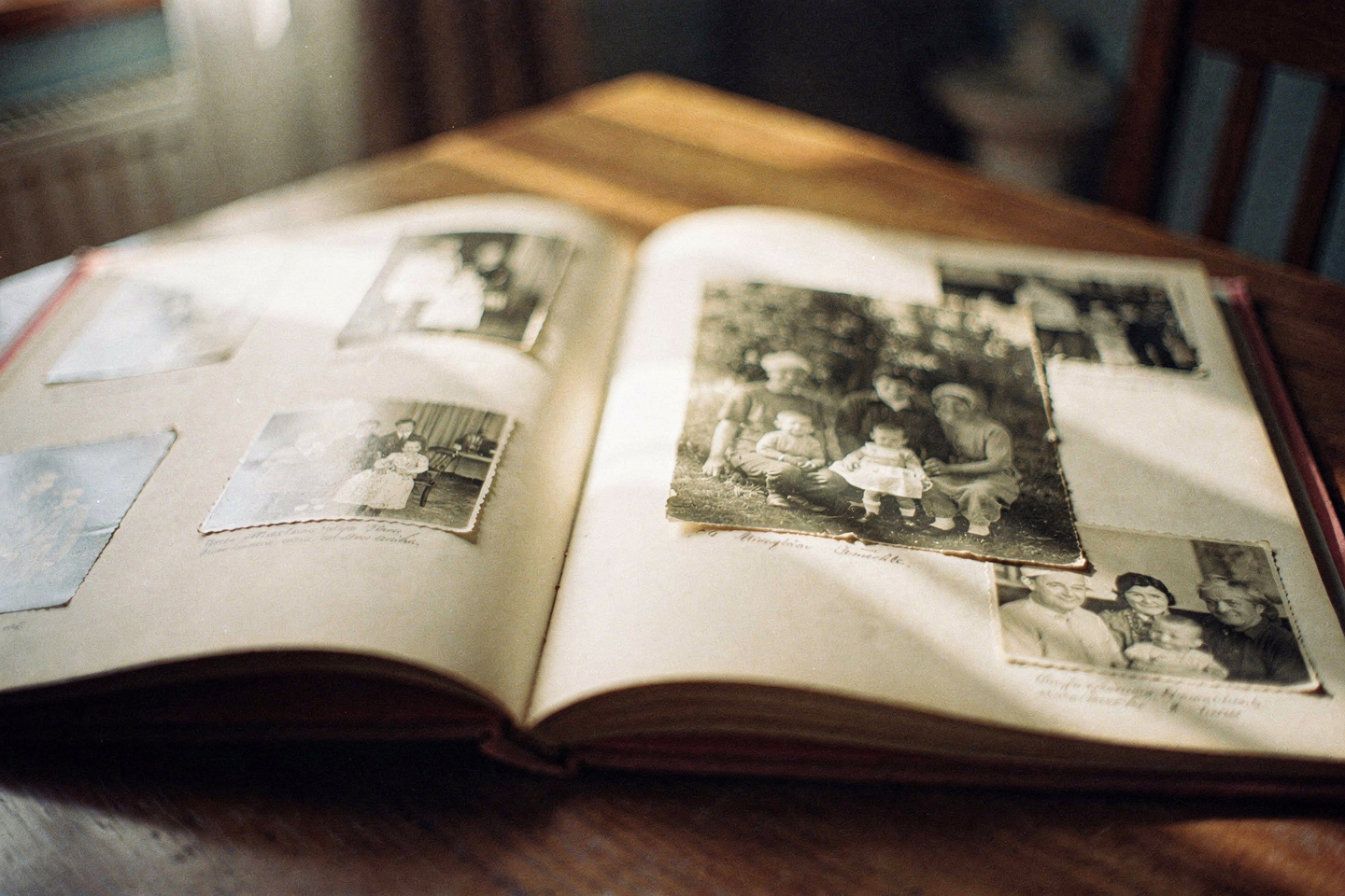 An open book with a printed narrative and old black-and-white photographs